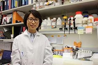 Female doctor with glasses standing in a lab